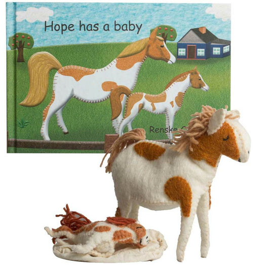 Hope has a baby book and toy | Papoose Toys